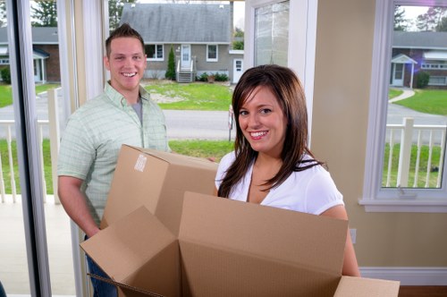 Professional movers handling boxes and furniture for a local home move in Eltham